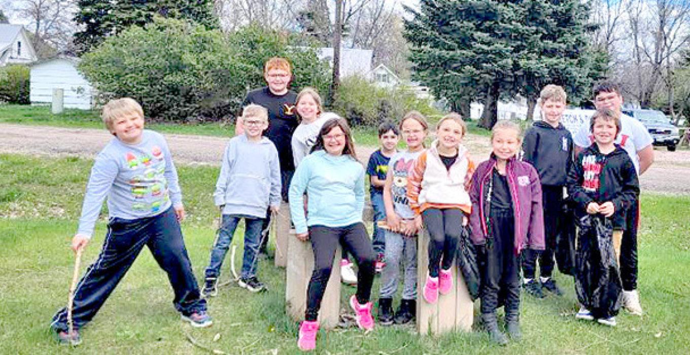 Second graders picked up sticks and trash around the frisbee golf area at the city park.