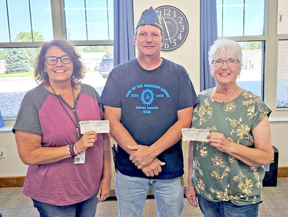 Squadron #6 members present checks to two of the three Gregory County senior meal programs. Allen Dobson, Detachment and Squadron #6 Sgt. at Arms, presents a $1,500 check to Karen Janousek (l), representing the Bonesteel/Fairfax area meals, while Sue Chytka (r) accepts a $1,500 check for the Burke senior meals. The funds were raised during the squadron’s August 2026 golf tournament.