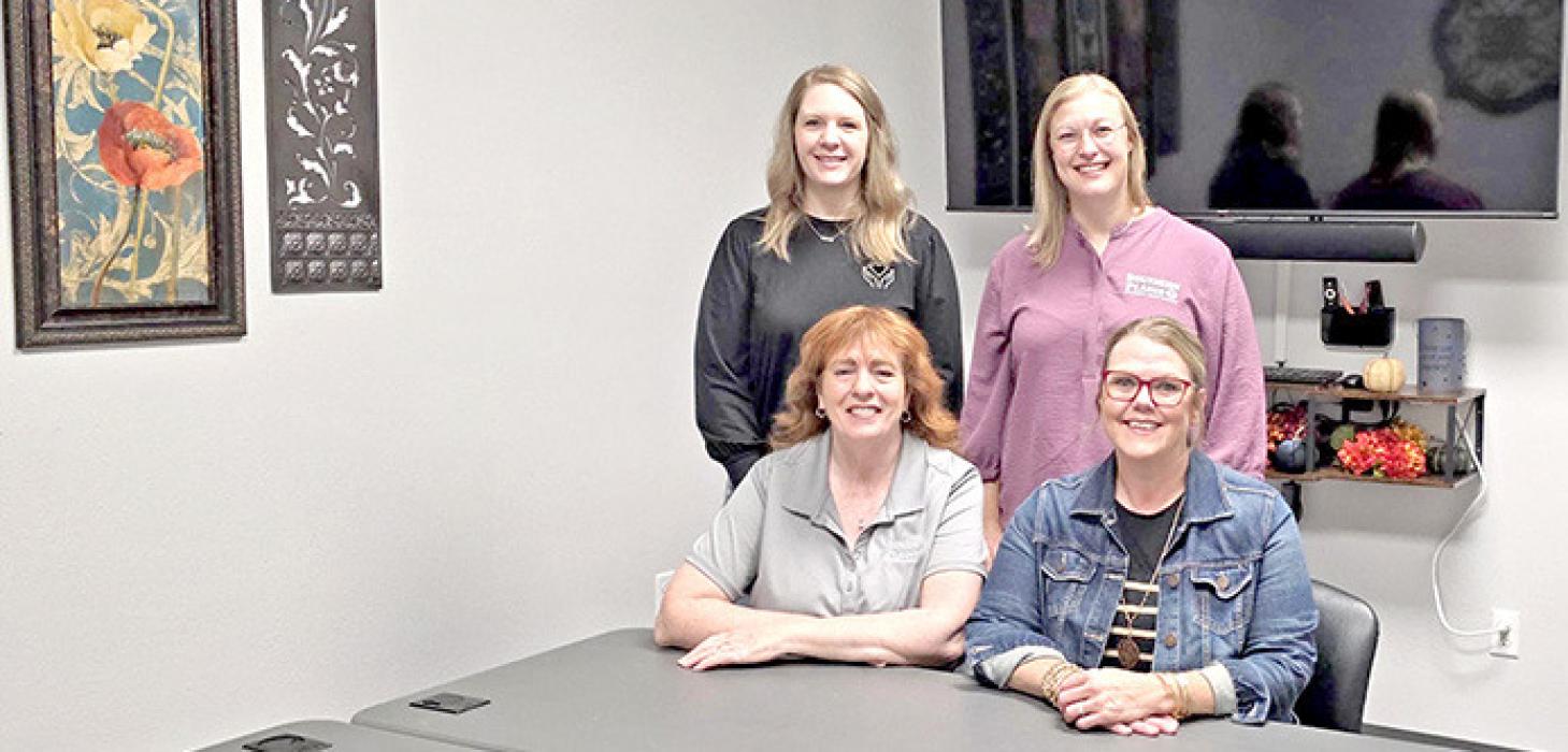 Emily Myrmoe and Lindsey McCarthy, standing, and Karla Zick and Liz VanOverschelde are shown here in the conference room which is also set up for video counseling appointments.