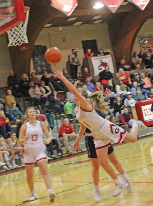 Morgan Opbroek, #1, flies in for a lay-up as #13 Gracie Kenzy prepares for a possible rebound in Gregory’s double header at home against Bon Homme Friday night.