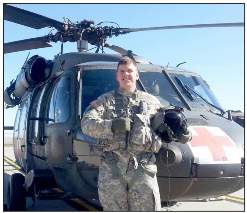 Major Tony Timanus is shown here next to one of the helicopters he flew during his 20 years of military service.