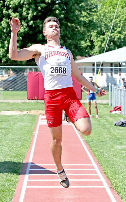 Rylan Peck stretches for extra inches in long jump.