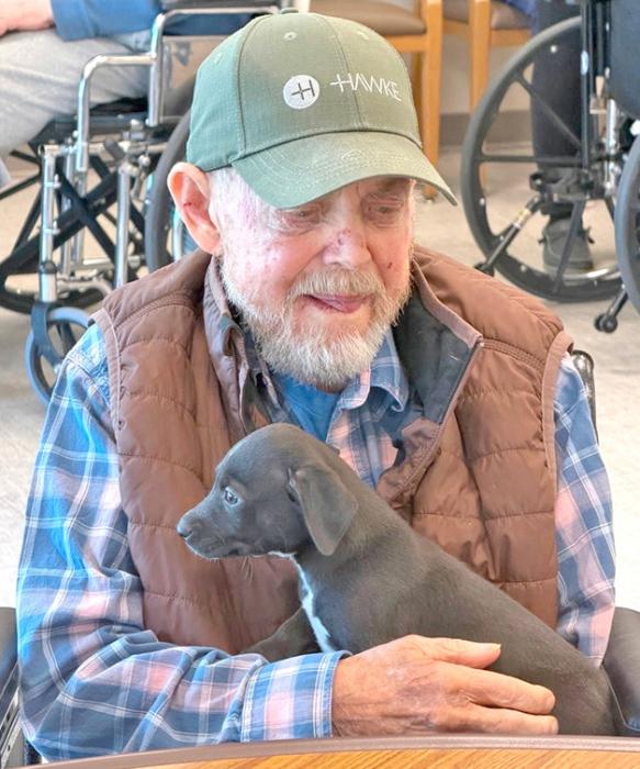 Kelly Kreinbuhl, formally of Iona, SD, with the puppy who wanted to snuggle.
