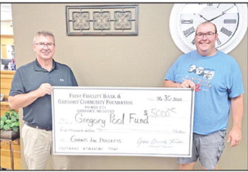 The Gregory Pool Fund, represented by Jared Opp, moves one step closer to achieving its fundraising goal after receiving a $5,000 grant from First Fidelity Bank and the Community Foundation, represented by Sam Flakus.