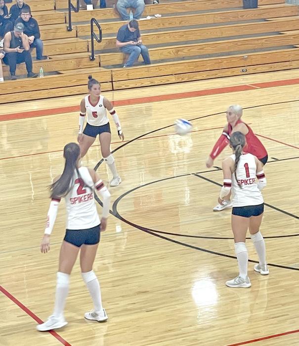 Gregory Lady Spikers move together to get the ball back up to the net. (Photo by Kristy Ring)