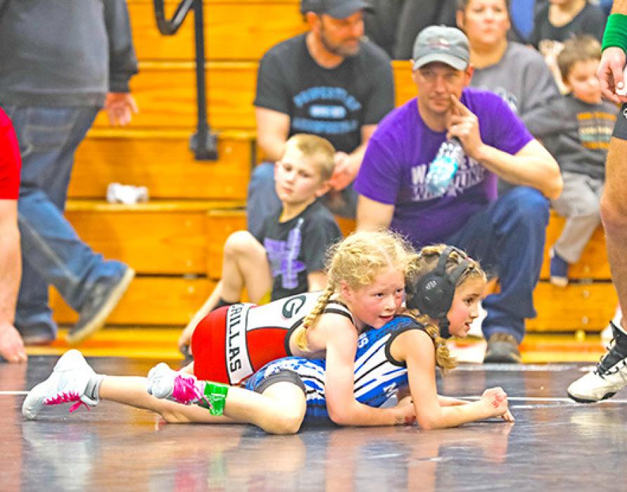 Norah Vosika works on turning her opponent on her way to first place. (Wrestling photos by Bailey Veskrna)