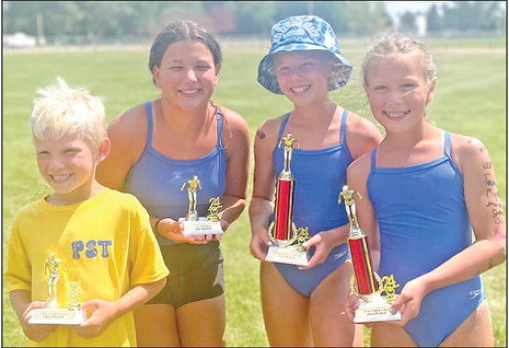 Jaxon Stukel, Hadley Braun, Averie Stukel, and Sutton Braun show their trophies.
