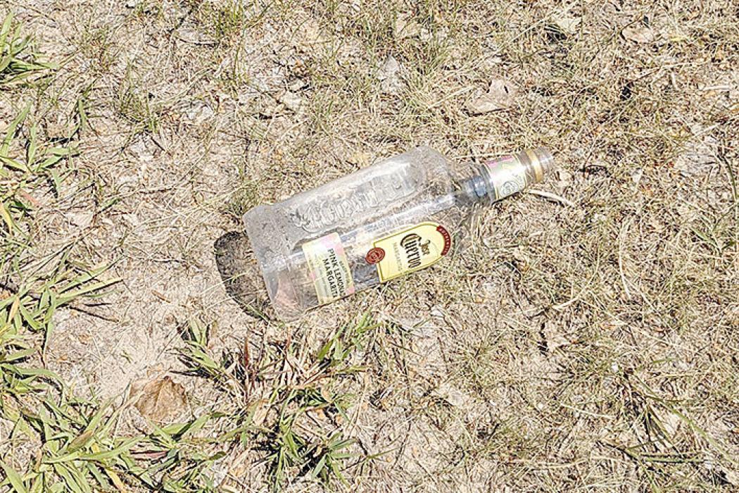 Photos fail to give a good idea of the mess partiers left behind at Burke Lake Saturday night. Bottles, cans, and other debris were thrown over a large area, leaving behind glass shards on the pavement and in the grass.