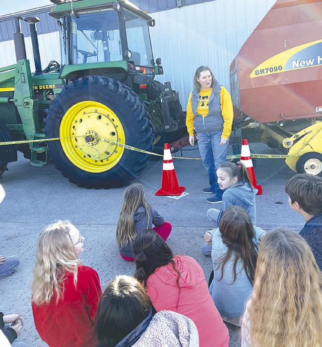 Mollie Andrews and FFA members demonstrate tractor safety to the Gregory students.