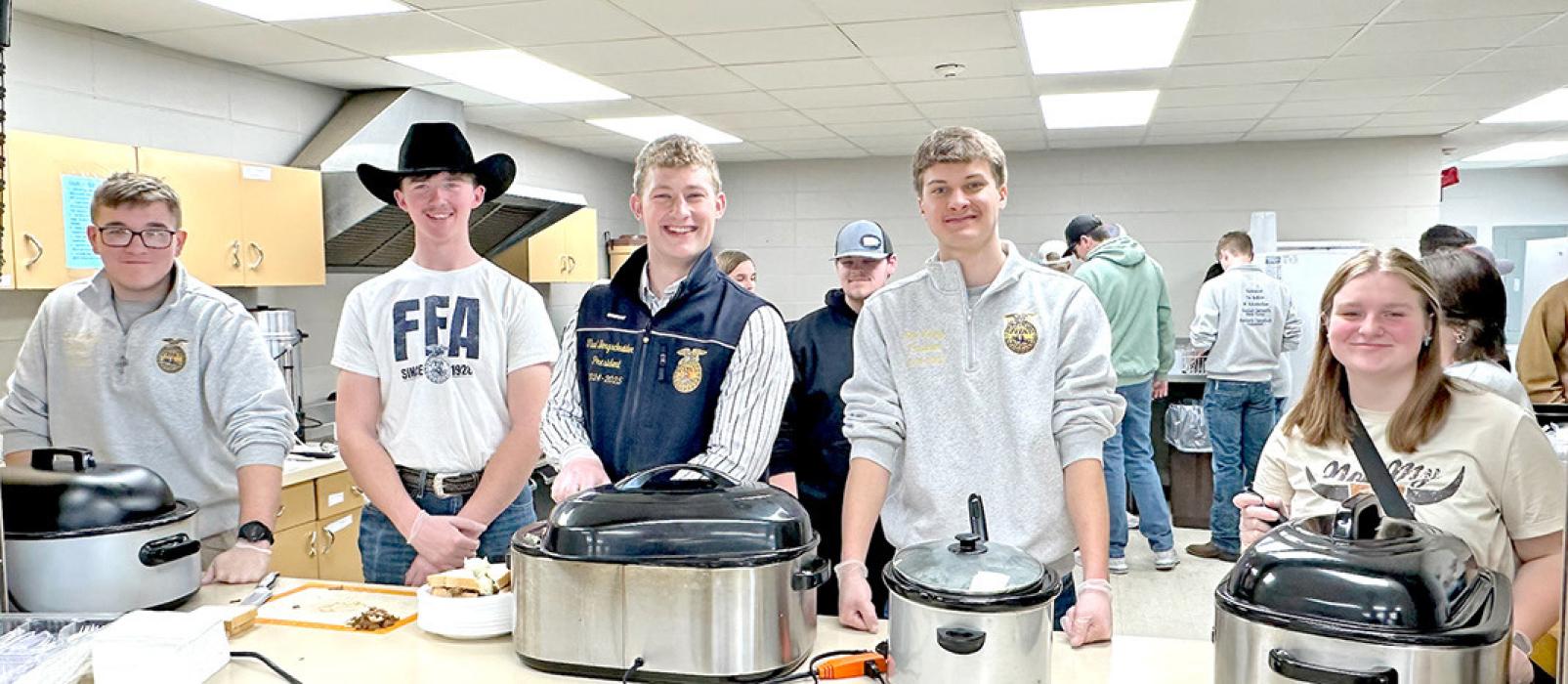 National FFA President Thad Bergschneider helped out in the kitchen, serving the meal with local chapter members. (Photo by Mollie Andrews)