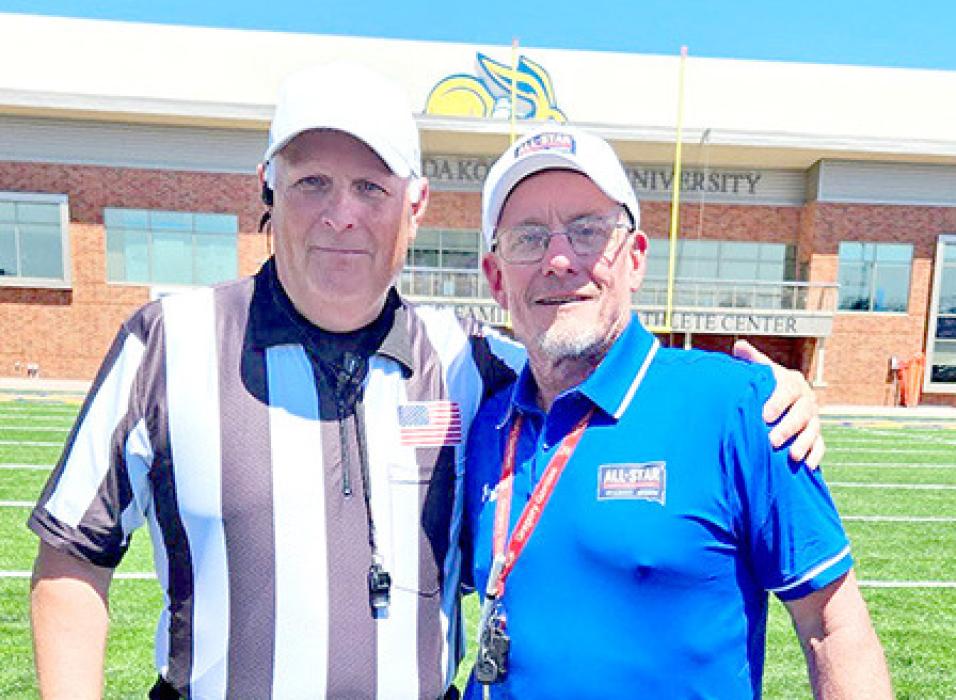 Coach King took time for a photo with Gregory alum Matt Clark, who was part of the team of officials for the game. (Submitted photo)