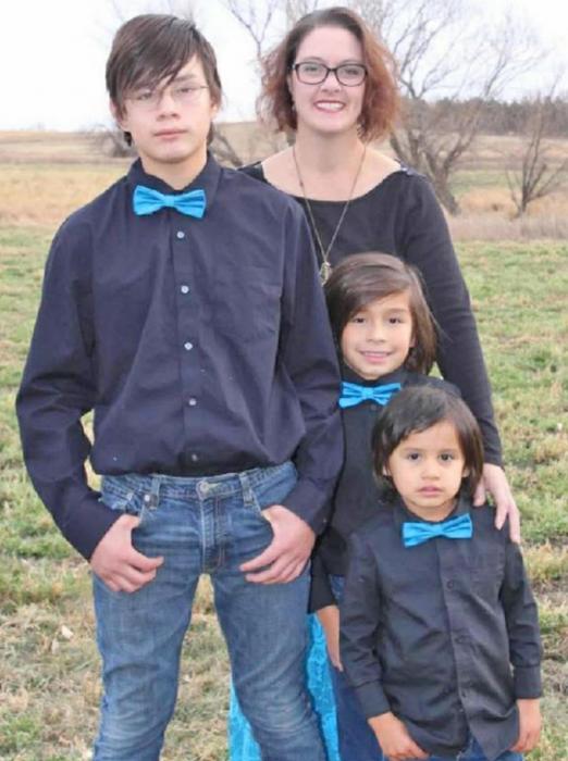 Suzanne Braun is shown with her three boys. Joe, whom she adopted, is the middle one. She is legal guardian of Dyrese and Misun, the tall one and short one. All three came to her through the foster system.