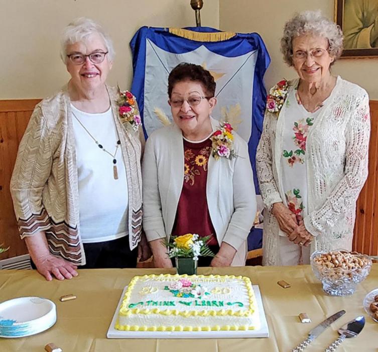 Three of the Think and Learn Club’s founding members, Kathy Kayl, Elaine Nemer, and Cathy Wernke, shown l to r, were able to attend the celebration and were honored with certificates of recognition and a flower.