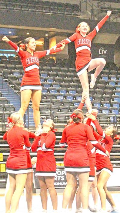 The girls perform one of their stunts in the cheer competition at state. (Photo by Jeff Determan)