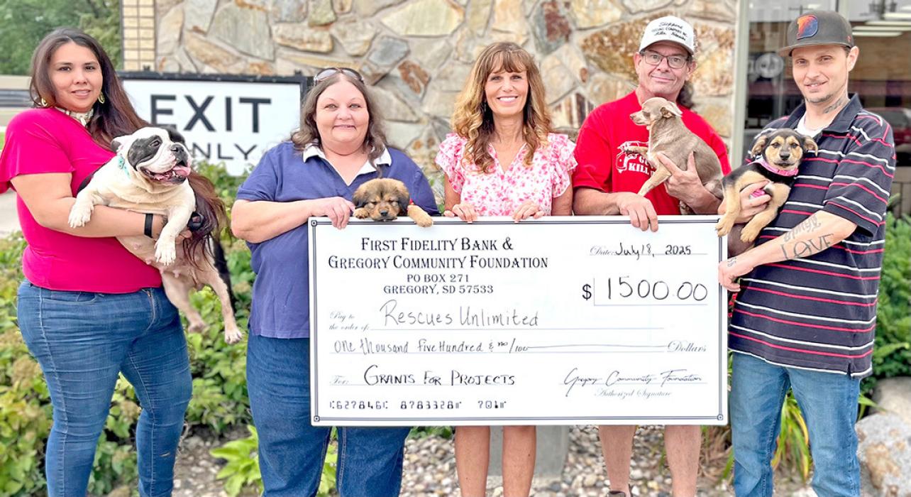 First Fidelity Bank and Gregory Community Foundation presented a $1,500 grant check to Rescues Unlimited, which has saved hundreds of animals, to use for upcoming projects. Representing Rescues Unlimited, from left to right, are Rose McCaulley, holding Moo-Moo, Marie Palmer with Arlo, Rhonda Vaughn-Waterbury (Gregory Foundation board member), Joey Meyers with Wessell, and John Watts holding Caramel.