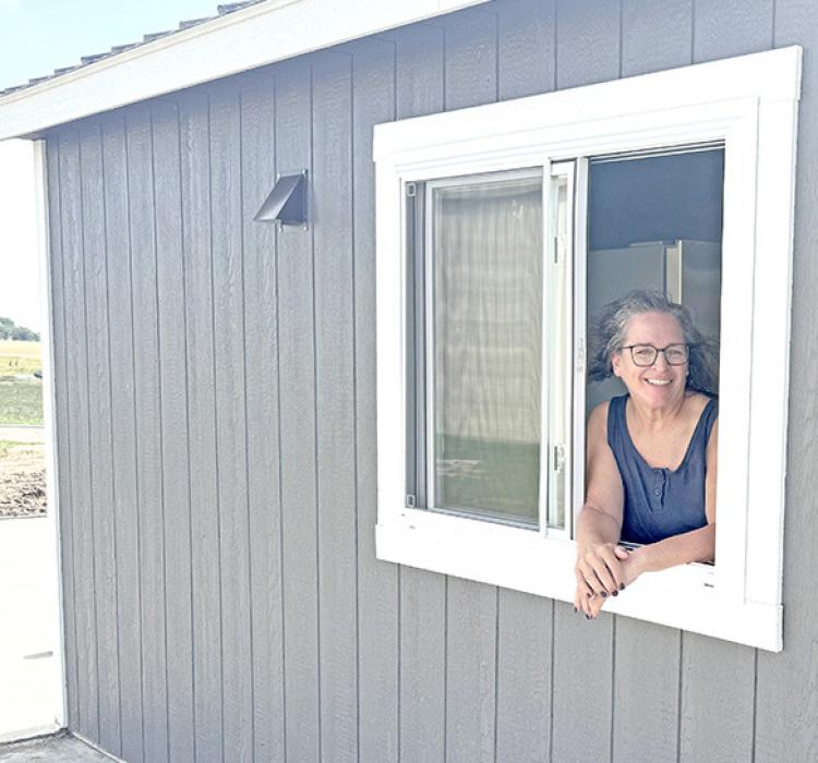 Kristi Drey, owner of the Train Station Ice Cream Shop, shows off the newly installed drive-through window.