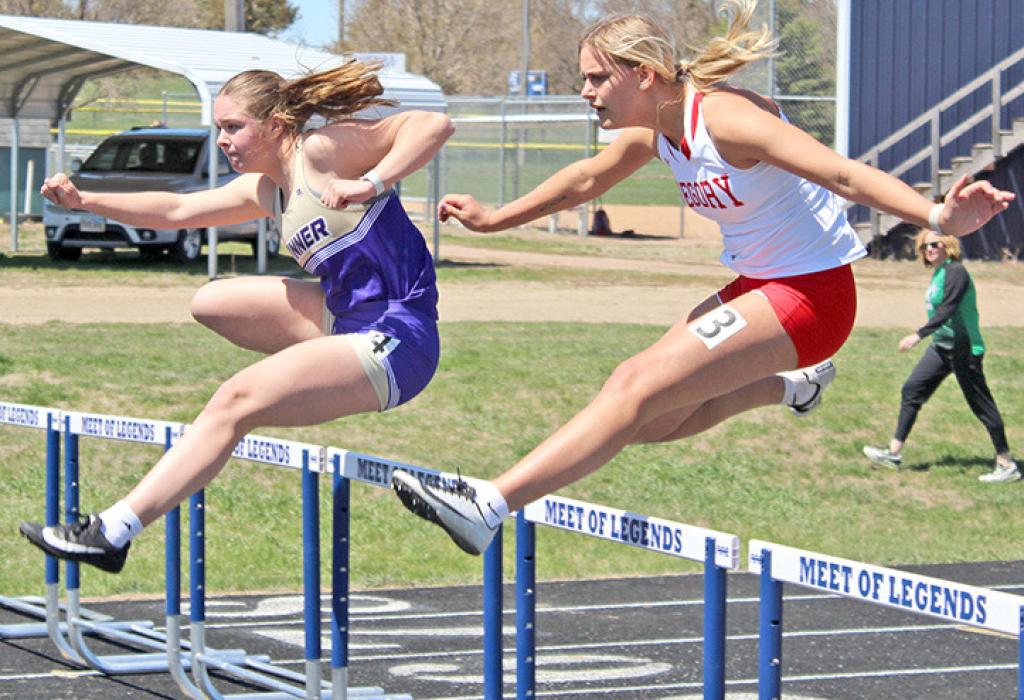 Raesha Beck keeps pace with a Winner runner in the hurdles. (Photo by Gracie Stephens)