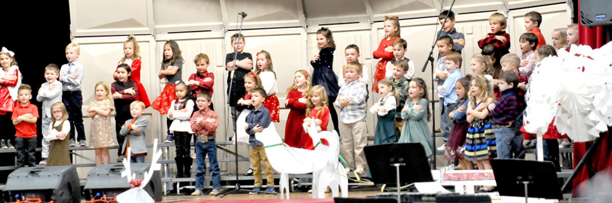 The Gregory B-K and kindergartern sang Mittens and Gloves and If I Could Fly Like A Snowflake during the concert under the direction of Katie Opp. The first and second graders, below, sang Christmas Card and Christmas in Any Language. The bottom picture is the performance of The Big Chill (Hoping for a Snow Day) by the third, fourth, and fifth grader.
