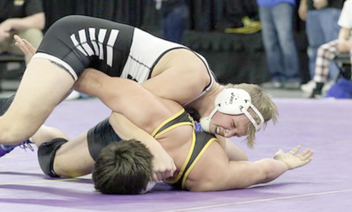 Kade Braun works on putting a Warner/Northwestern wrestler on his back. (Photo by Lenna Braun)