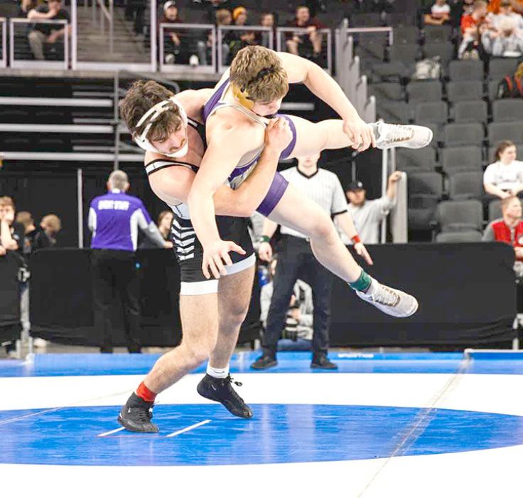 Jhett Eklund went 4-1 in the tournament to earn a third place finish. He is shown here throwing Curtis of Winner in a takedown. (Photo by Jacob Nielson, South Dakota Public Broadcasting)