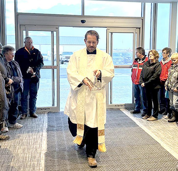 Fr. Jonathan Dillon blessed the main doors of the hospital during the blessing ceremony.