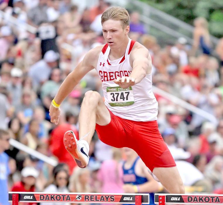 Left, Colt Keiser clears a hurdle in the 300 m hurdles to finish in 5th place. (Photo by 605 Sports)