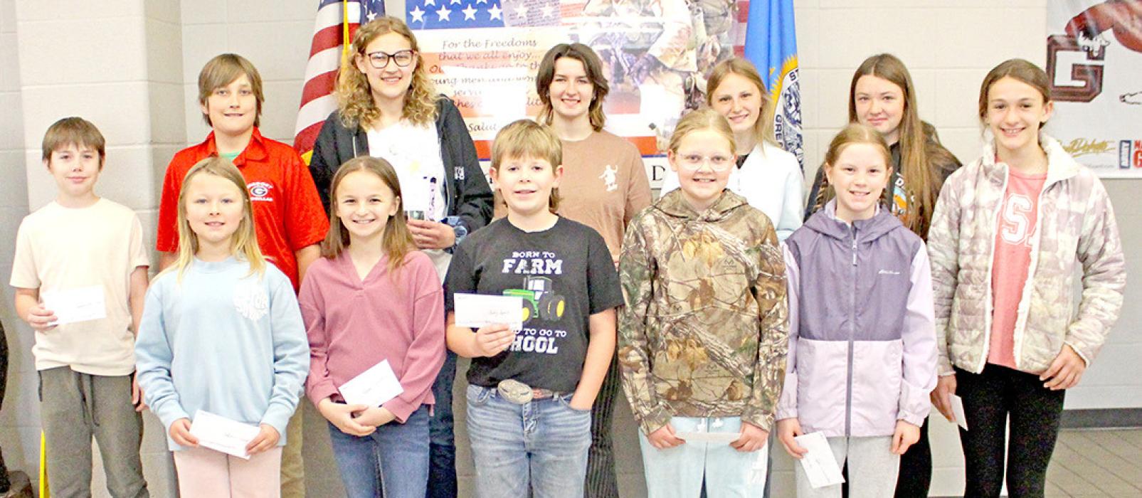 All the place winners in the Dallas American Legion Poppy Poster Contest are shown above. They are, back row, l to r: Joseph Stevicks, Ben Engel, Claire Engel, Shyanna Steffen, Sadie Carlson, Sophee Skalla, and Avaya Vomacka; front row, l to r: Adeline Beck, Meadow Wonnenberg, Sully Sperl, Katherine Engel, and Lydia Wonnenberg. (Photos by Kristy Ring)