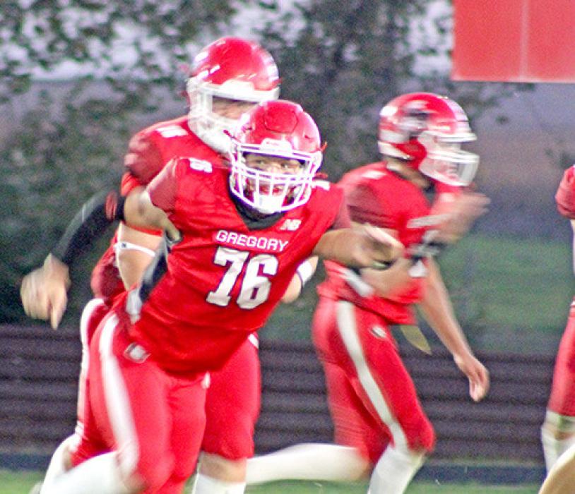 Center Austin Vosika, #75 prepares to snap the ball. Dale Smikle, #76 (top right) keeps his eye on the play. (Photo by George Timanus)