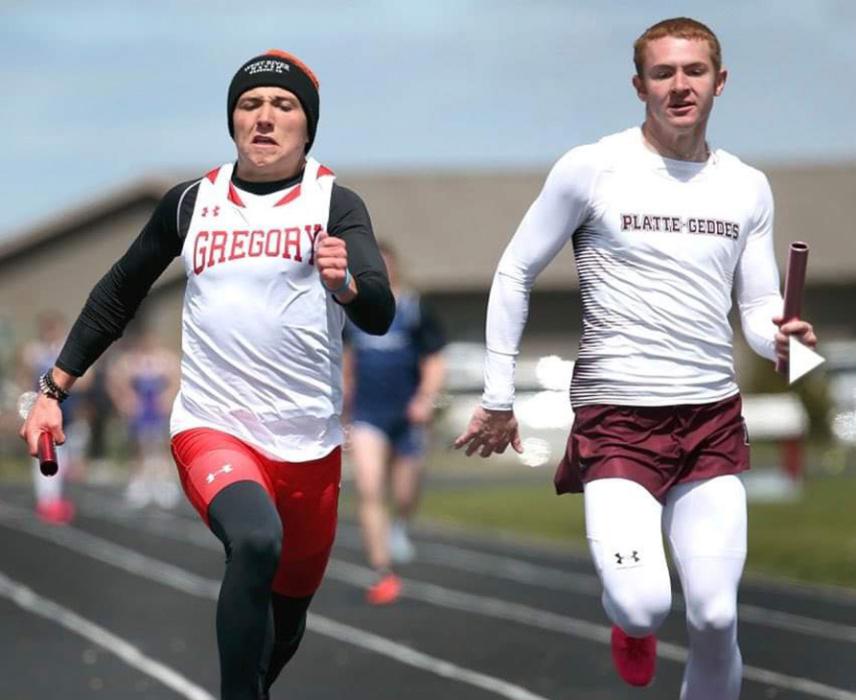 Luke Stukel is shown here anchoring the 4x100 relay to help the team to a first place finish. (Photo by Kellie Stukel)