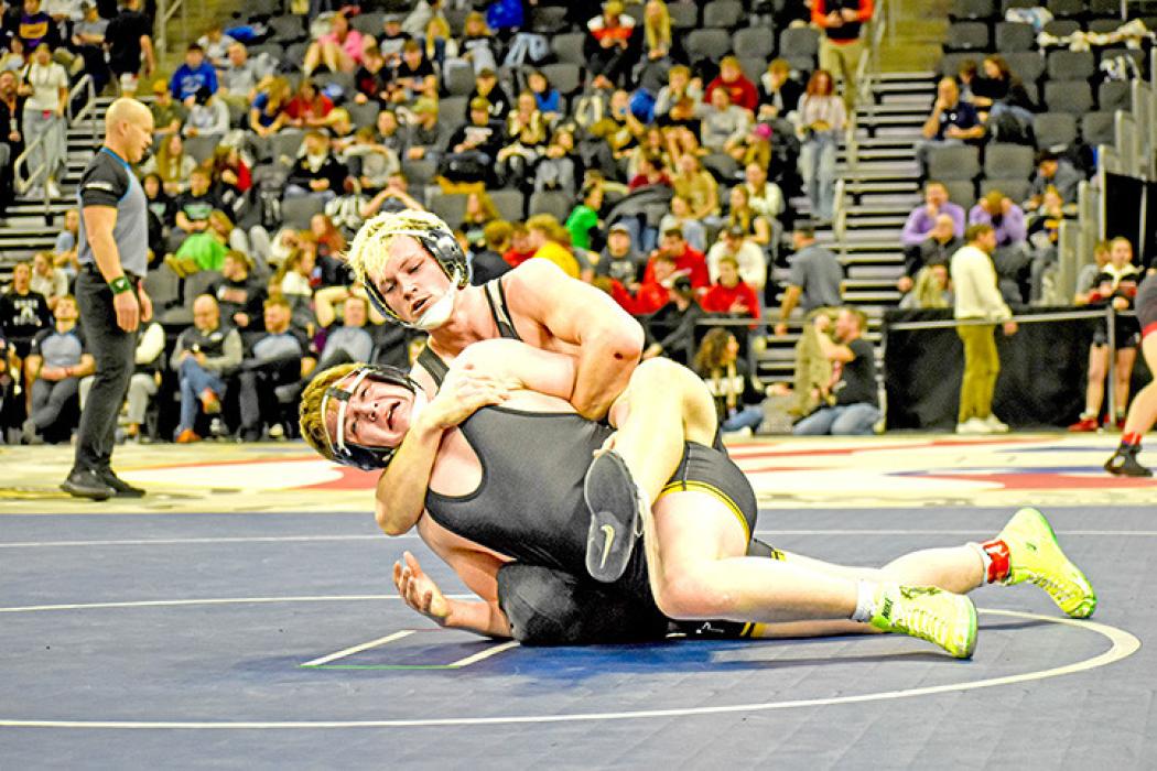 Senior Mason Janak works to turn his opponent over for a pin. (Photo by Kamre Peabody)
