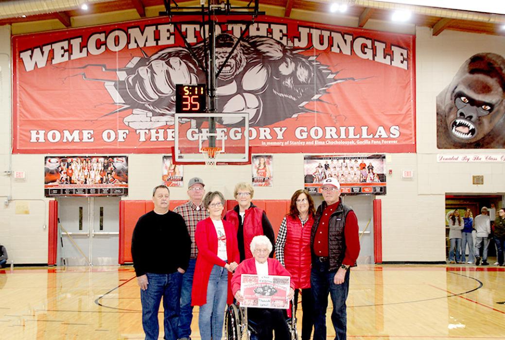 The new “Welcome to the Jungle” banner was purchased as a memorial to Stanley and Elma Chocholousek, perennial fans of the Gregory School District. Pictured in front, l to r: Roger and Julie Greer, Elma Chocholousek, Roxie and Dave Chocholousek, and Dennis and Linda Purvis in the back.