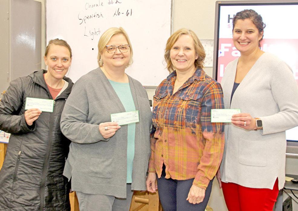 Valerie Johnson of P.E.O. Chapter Z (second from the right) presented project grants to Britany Reber, Holly Whitney, and Jacque Bartling, shown l to r. Gaile Sachtjen of Burke, not pictured, also received a project grant.