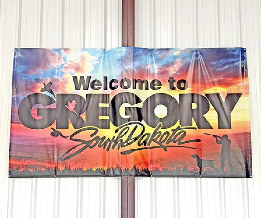 The new Welcome to Gregory South Dakota sign is in the big hangar at the Gregory Municipal Airport/Flynn Field. This sign is meant to welcome pilots to our area and serve as a thank you for choosing Gregory Municipal Airport. There is also a new sign listing the hangar fees and a convenient drop box for payment. The new signs were paid for with money the airport receives from the fuel taxes.