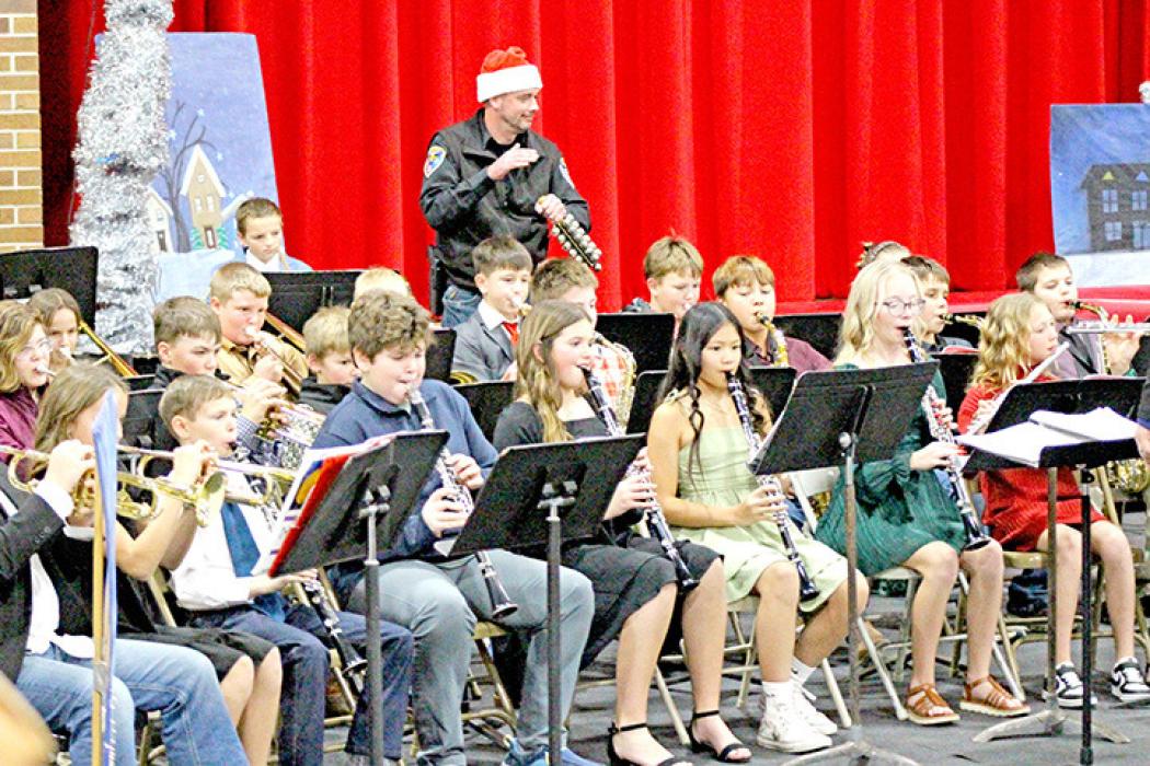 Police Chief Ryan Cook showed that he is a man of many talents, lending a hand to the fifth grade band on Jingle Bells.