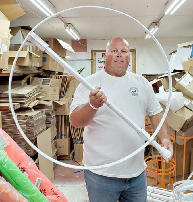 Mike holds the bottom ring of a 36-inch diameter frame, which will provide support for a 12-foot windsock, the largest size they manufacture.