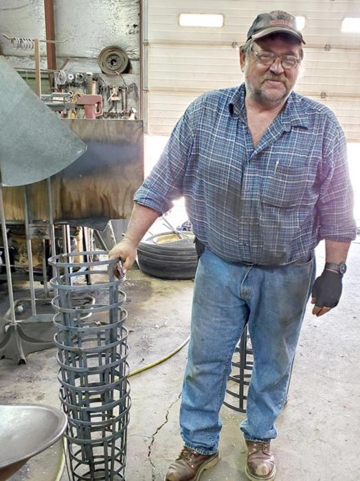 James works at the farm building the frames for the windsocks. He bends strips of metal into rings and welds everything together before sending them off to be powdercoated.