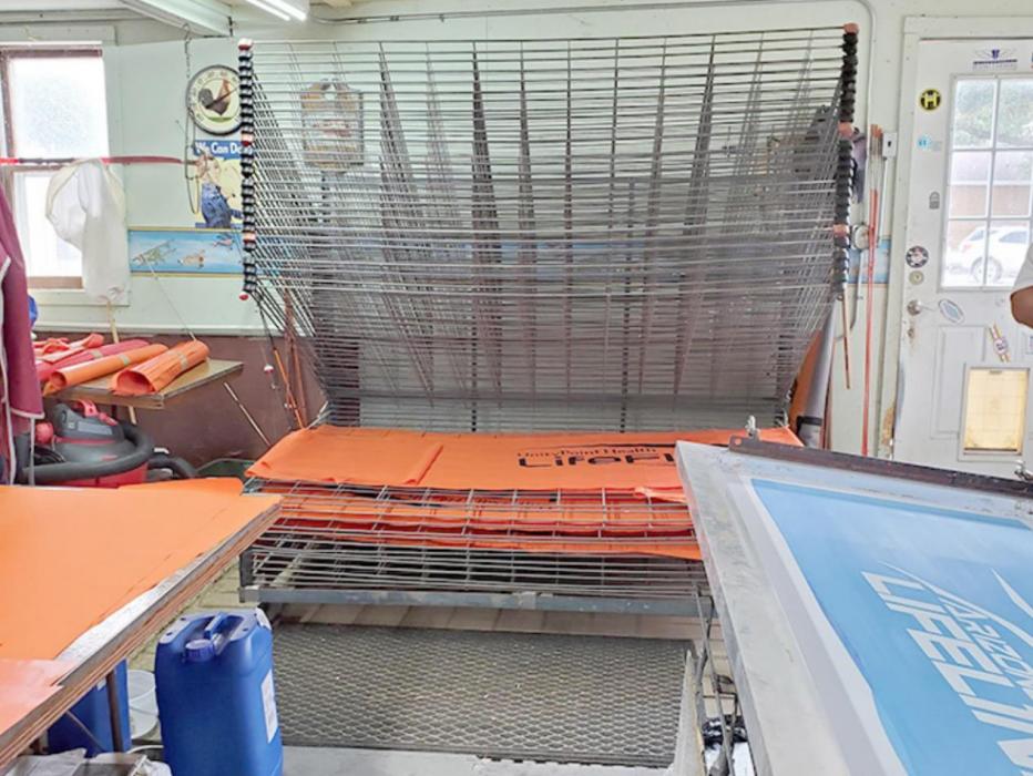 Unlike t-shirt printing, which can be flash dried, each color on a windsock has to dry for two days, and multicolor designs take a lot more work. The hog barn where they do their screen printing has enough drying racks to hold hundreds of screen printed panels.