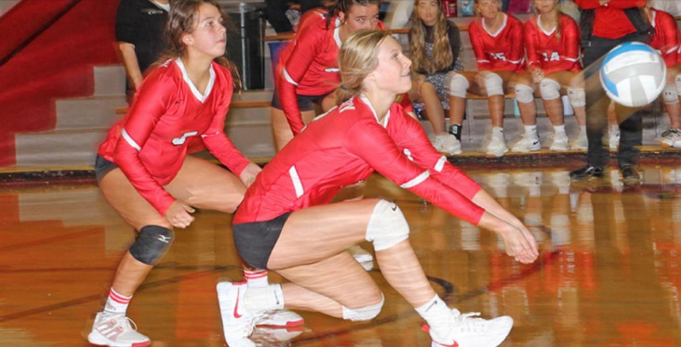 Brooklyn Kenzy goes low for a bump on a serve reception.