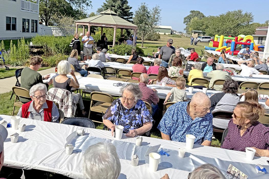 Residents of Silver Threads, along with family and friends, enjoyed an afternoon outdooors with bouncy houses, a potluck, cake, and entertainment by the Java Jives.