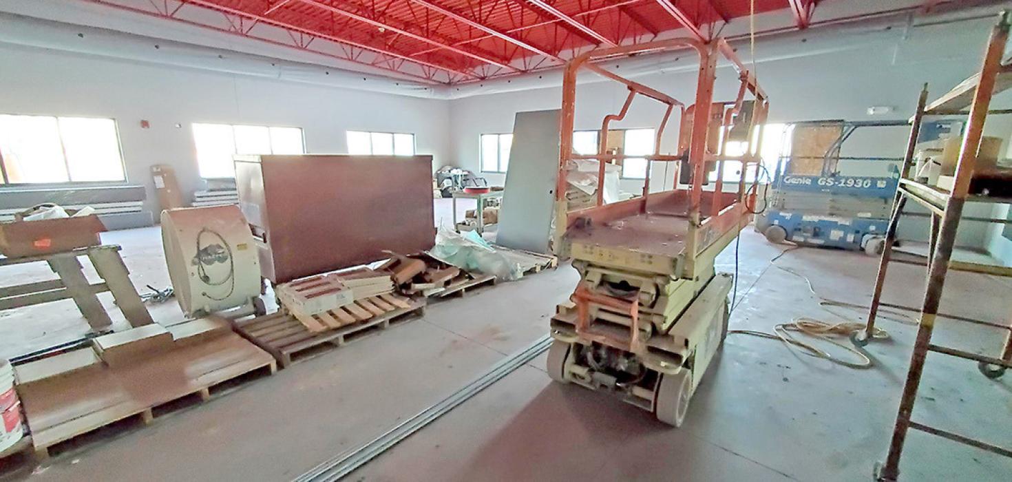 The weight room at the new wellness center at the school features lots of windows and a wall of mirror to check form when lifting weights.