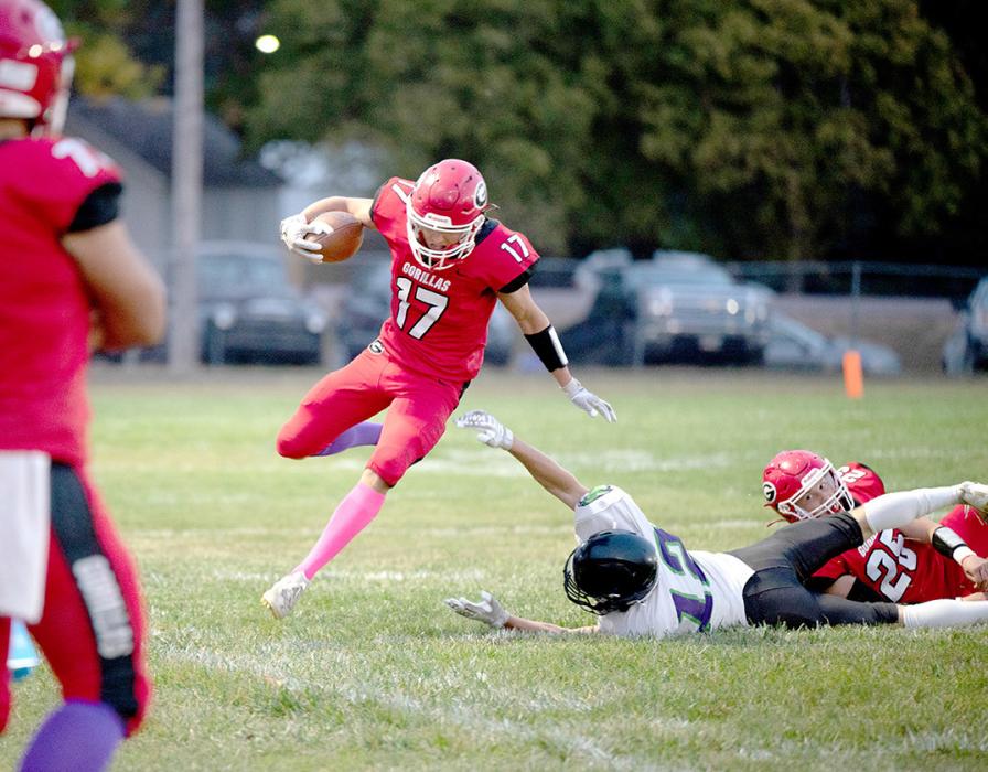 Luke Stukel, #17, takes advantage of a clearance created by Paul Sinclair, #25, to gain some yardage in Friday night’s Homecoming game against Kimball/White Lake. (Photo by Calli Jo Photography)