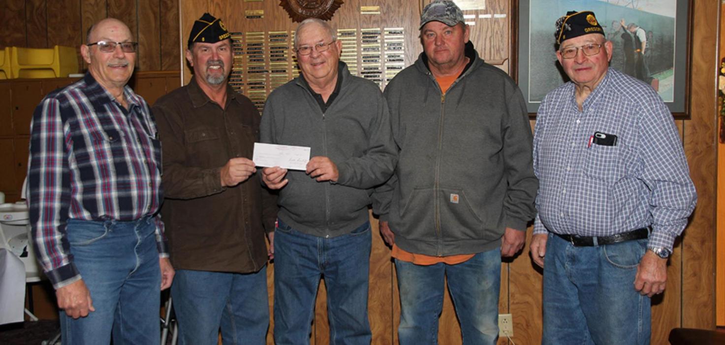 Ron Kyburz, center, representing the Gregory Community Foundation, presents a check for $1,000 to Legion Vice Commander Greg Smith, second from left. Other members of the Legion remodeling committee include Dick Shaffer, left, and project/construction manager Joe Klein, second from right, and Gerald Gergen, right.