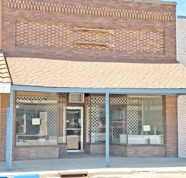 Another old building on Main Street is the former flower shop. Although “sale” is painted on the window, no real estate signs are present.