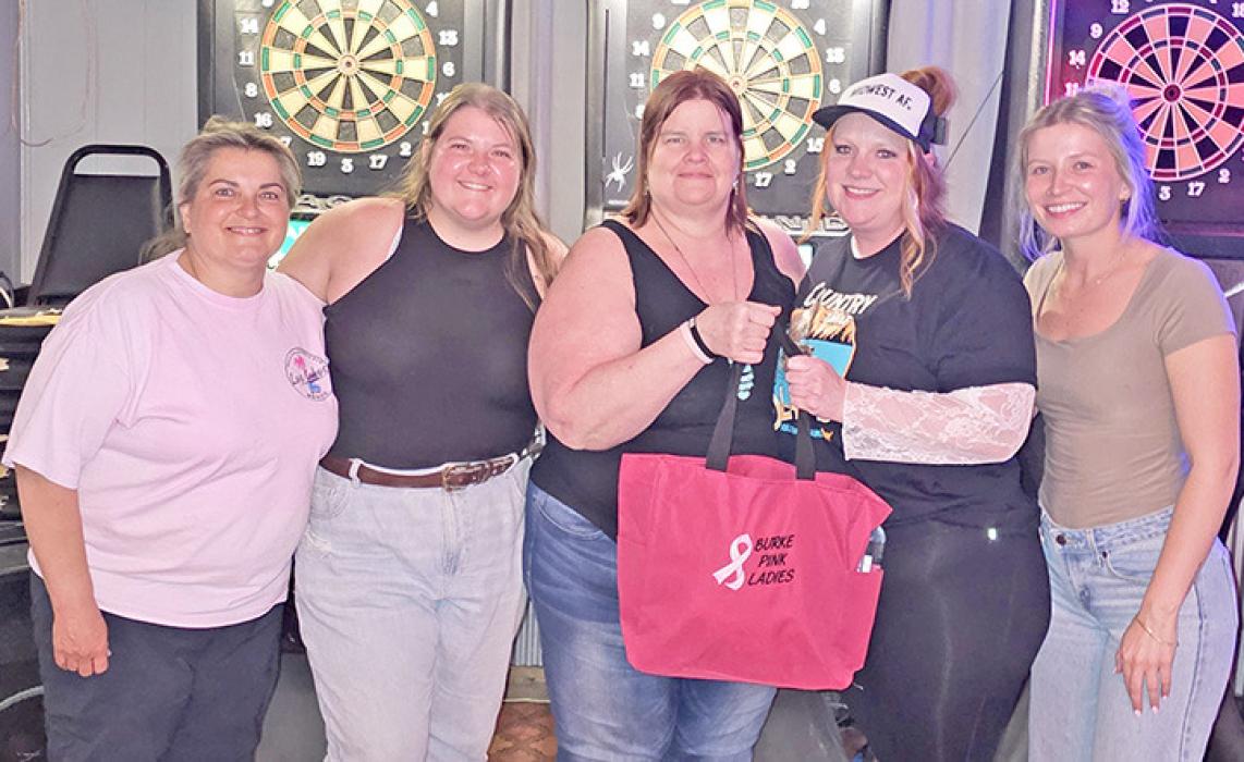 After a make-up game of darts, Pink Lady Members presented a warrior bag to one of their own. Presenting the bag was treasurer Shannyn Schweigert, Shannon Weller, president Larea Matucha, and the warrior receiving the bag, Jessica Martin, and Ahna Schweigert.