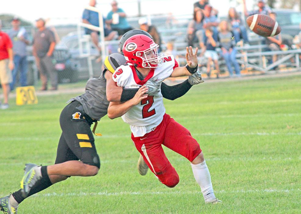 Gannon Thomas, above, follows his blockers to gain some yardage against the Wolsey-Wessington Warbirds Friday night. He ran for a total of 89 yards in ten carries and scored two touchdowns. Rylan Peck, right, gets the ball off in time to beat a tackle. He threw for 59 yards with four completions. He was also second in rushing yards in the game with 57 in 11 carries. (Photos by Ryan Deal, 605 Sports)