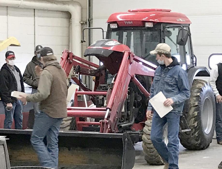 Tyler and Mason P identifying parts on tractor for Ag Mechanics.