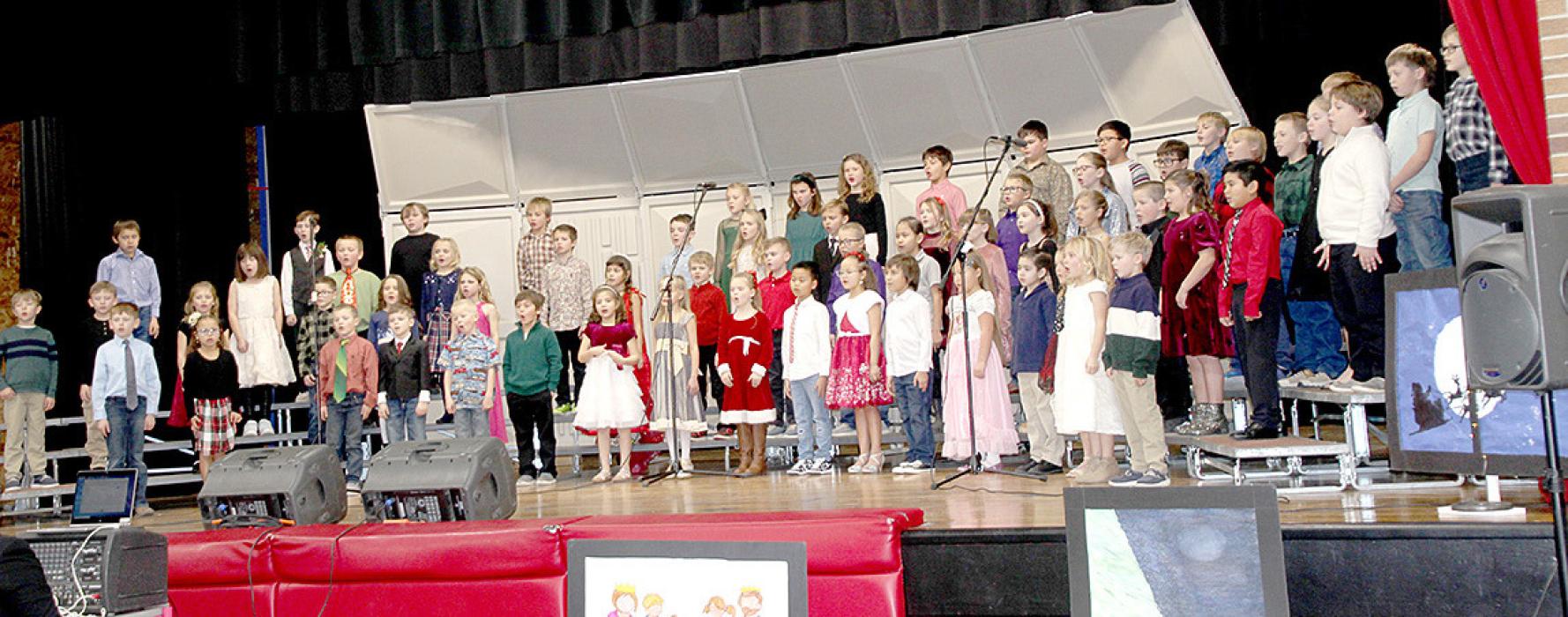 The first and second grade students joined together to perform When the Holidays Come and Joy to the world.