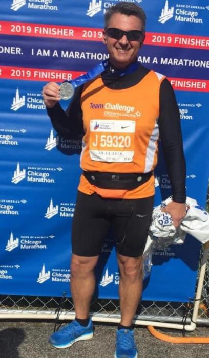 Wade Juracek shows his medal after completing the Chicago Marathon in 2019.
