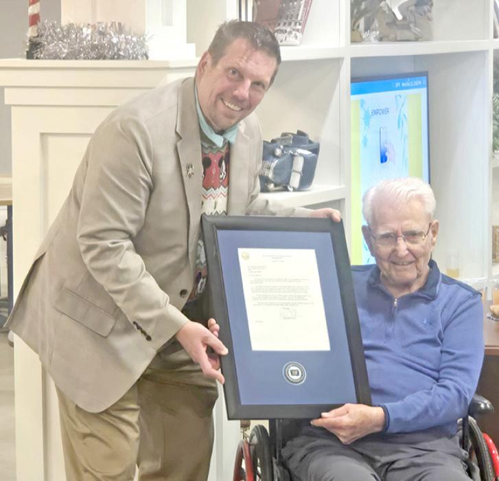 Retired Lt. Col. Michael Ingram, a Patient Advocate Volunteer from the Omaha VA Medical Campus, presented Lawrence “Vince” Berens with a national VA commendation on December 22, 2025, at the Aviva Assisted Living Facility in Lincoln, Nebraska.