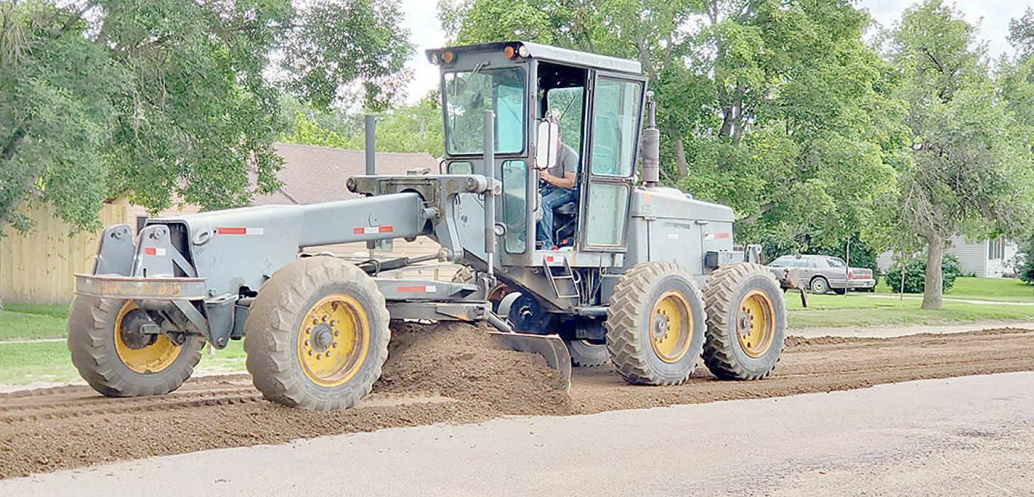 Public Works Superintendent Josey Larsen spreads gravel on Rosebud Avenue in preparation for milling. After the streets have been milled, they will be resurfaced. A total of 42 blocks are slated for resurfacing this summer. The project is expected to be completed by the end of August.